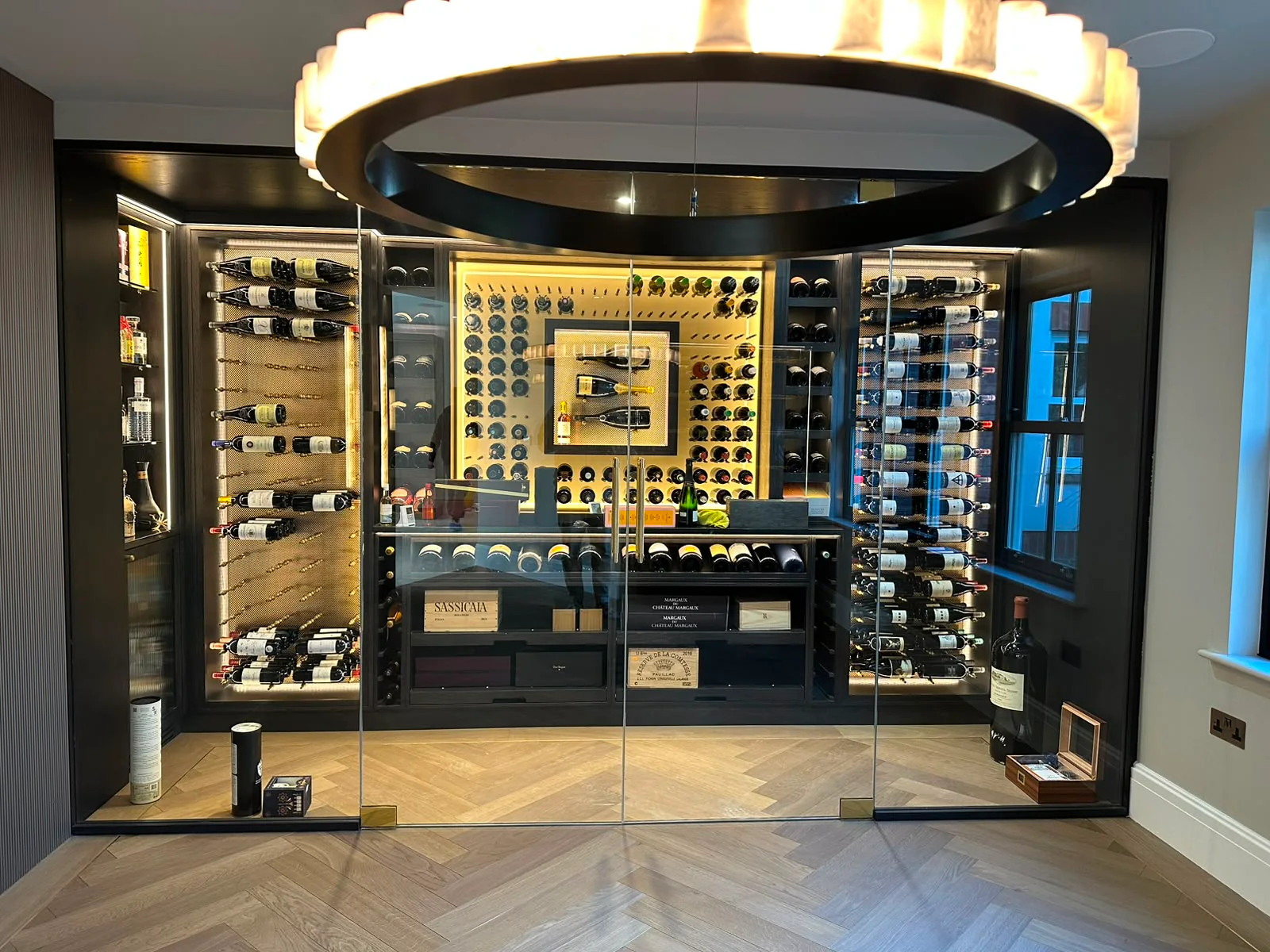 Completed JP Home Creations wine room with glazed doors and illuminated bottle storage